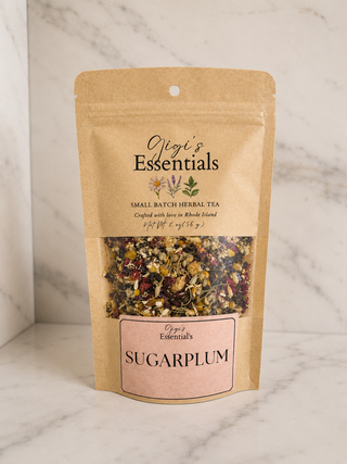 Kraft paper tea bag with 'Gigi's Essentials' branding on a marble background